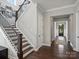 Beautiful staircase and entryway featuring hardwood floors and iron railing at 822 River Oaks Ln, Charlotte, NC 28226