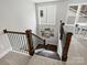 Staircase with hardwood steps and a wrought iron railing, complemented by natural light from nearby windows at 822 River Oaks Ln, Charlotte, NC 28226