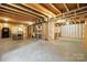 Unfinished basement area ready for customization, featuring exposed beams and plenty of open space at 8427 Penton Pl, Harrisburg, NC 28075