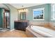 Bathroom featuring a soaking tub with tile surround, granite countertops, and walk-in shower at 8427 Penton Pl, Harrisburg, NC 28075