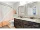 Functional bathroom with dual sinks, granite countertops, and neutral-toned tile flooring at 8427 Penton Pl, Harrisburg, NC 28075