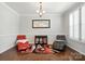 Formal dining area with hardwood floors and elegant lighting next to front foyer at 8427 Penton Pl, Harrisburg, NC 28075