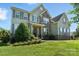 Attractive home with gray siding, stone features, and a lush green lawn at 8427 Penton Pl, Harrisburg, NC 28075