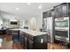 Kitchen island with granite countertop and stainless steel refrigerator and oven at 8427 Penton Pl, Harrisburg, NC 28075