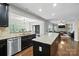 Spacious kitchen with stainless steel appliances, granite countertops and a view to the living room at 8427 Penton Pl, Harrisburg, NC 28075