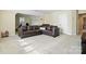Comfortable living room with a large sectional sofa and neutral carpet at 8427 Penton Pl, Harrisburg, NC 28075