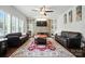 Comfortable living room with a decorative rug, fireplace, and built-in shelving at 8427 Penton Pl, Harrisburg, NC 28075