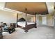 Spacious main bedroom featuring a luxurious four-poster bed and neutral decor at 8427 Penton Pl, Harrisburg, NC 28075
