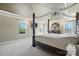 Spacious main bedroom with tray ceilings, neutral walls, and large windows at 8427 Penton Pl, Harrisburg, NC 28075