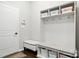 Mudroom with seating, hooks, and shelving for storage at 8427 Penton Pl, Harrisburg, NC 28075