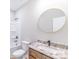 Bathroom featuring granite-topped vanity, a round mirror, and a bath tub at 1010 Oneil Dr, Monroe, NC 28112