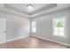 Bedroom with tray ceiling, chandelier and hardwood floors is well-lit by dual windows at 1010 Oneil Dr, Monroe, NC 28112