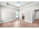Bedroom with hardwood floors, trey ceiling, and views into the bathroom at 1010 Oneil Dr, Monroe, NC 28112