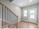 Bright foyer featuring hardwood floors, stairs, and a glass paned front door at 1010 Oneil Dr, Monroe, NC 28112