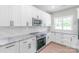 Modern kitchen featuring white cabinets, stainless steel appliances, and granite countertops at 1010 Oneil Dr, Monroe, NC 28112