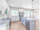 Open kitchen with island seating, pendant lighting, stainless appliances, and white cabinets at 1010 Oneil Dr, Monroe, NC 28112