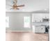 Bright, open kitchen featuring white cabinets, modern appliances, and a stylish ceiling fan at 1010 Oneil Dr, Monroe, NC 28112