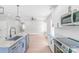 Open kitchen with island seating, pendant lighting, stainless appliances, and tile backsplash at 1010 Oneil Dr, Monroe, NC 28112