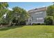 Spacious backyard featuring green grass and lush trees at 10121 Edgecliff Rd, Huntersville, NC 28078