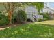 A beautiful backyard with a wooden deck, lush lawn, and mature trees provides a relaxing outdoor space at 10121 Edgecliff Rd, Huntersville, NC 28078