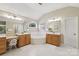 Bright bathroom featuring dual sinks, a soaking tub, and a separate makeup vanity at 10121 Edgecliff Rd, Huntersville, NC 28078