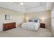 Expansive main bedroom featuring a tray ceiling, dresser, and a bright window at 10121 Edgecliff Rd, Huntersville, NC 28078