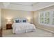 Spacious main bedroom with a tray ceiling, two nightstands, and bright window at 10121 Edgecliff Rd, Huntersville, NC 28078
