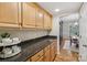 Butler's pantry with granite countertops and custom cabinetry adjacent to dining room at 10121 Edgecliff Rd, Huntersville, NC 28078