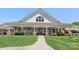 The community clubhouse boasts a covered porch, manicured landscaping, and inviting seating areas at 10121 Edgecliff Rd, Huntersville, NC 28078