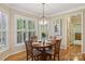 Bright dining room with a chandelier, hardwood floors, and natural light from large windows at 10121 Edgecliff Rd, Huntersville, NC 28078