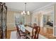 Dining room featuring hardwood floors, modern chandelier, and lots of light at 10121 Edgecliff Rd, Huntersville, NC 28078