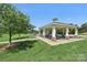 Open-air gazebo with seating, set in a grassy park-like area with trees and walking paths at 10121 Edgecliff Rd, Huntersville, NC 28078