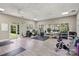 Bright gym space with ample workout equipment, mirrors, and natural light from multiple windows at 10121 Edgecliff Rd, Huntersville, NC 28078