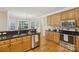 Well-lit kitchen featuring granite counters, stainless appliances and hardwood floors at 10121 Edgecliff Rd, Huntersville, NC 28078