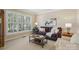Cozy living room with plush seating, window with shutters, and soft natural light at 10121 Edgecliff Rd, Huntersville, NC 28078