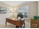 Bright office space with natural light, a wooden desk, and neutral decor at 10121 Edgecliff Rd, Huntersville, NC 28078