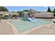 Community splash pad featuring slides and water features, surrounded by lounge seating and well-maintained landscaping at 10121 Edgecliff Rd, Huntersville, NC 28078
