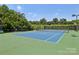 Community tennis court with green and blue surfaces, surrounded by a tall, dark fence at 10121 Edgecliff Rd, Huntersville, NC 28078