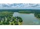 Aerial view of lakefront properties nestled amidst lush greenery and mature trees, offering scenic waterfront living at 1069 Westlake Dr, Kannapolis, NC 28081