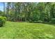 Expansive backyard with towering trees and a lush lawn, offering a serene and private outdoor retreat at 1069 Westlake Dr, Kannapolis, NC 28081