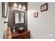 Charming powder room featuring a unique vanity with vessel sink and textured wall at 1069 Westlake Dr, Kannapolis, NC 28081