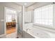 Bright bathroom featuring a soaking tub, glass-enclosed shower, and tile floors, offering a spa-like experience at 1069 Westlake Dr, Kannapolis, NC 28081