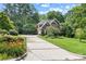Beautifully landscaped front yard with mature trees and a long driveway leading to a classic brick home at 1069 Westlake Dr, Kannapolis, NC 28081
