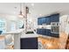 Modern kitchen with navy cabinets, stainless steel appliances, marble counters, and stylish pendant lighting at 1069 Westlake Dr, Kannapolis, NC 28081
