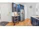 Charming kitchen with navy cabinets, stainless steel fridge, and functional ladder for storage at 1069 Westlake Dr, Kannapolis, NC 28081
