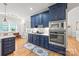 Modern kitchen featuring navy cabinetry, stainless steel appliances, and marble countertops at 1069 Westlake Dr, Kannapolis, NC 28081