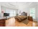 Spacious main bedroom with a tray ceiling, chandelier, hardwood floors, and ample natural light at 1069 Westlake Dr, Kannapolis, NC 28081