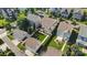 Aerial view of houses with well-manicured lawns, in-ground fire pit, and an outdoor gazebo at 11806 Stirling Field Dr, Pineville, NC 28134