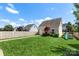 Spacious backyard with lush green lawn, play set, and privacy fence at 11806 Stirling Field Dr, Pineville, NC 28134
