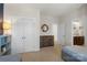 Cozy bedroom with neutral walls, a wooden dresser, and direct access to the bathroom at 11806 Stirling Field Dr, Pineville, NC 28134